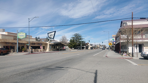 Main Street in Lone Pine, CA. There's some storefronts but hardly cars on the road.