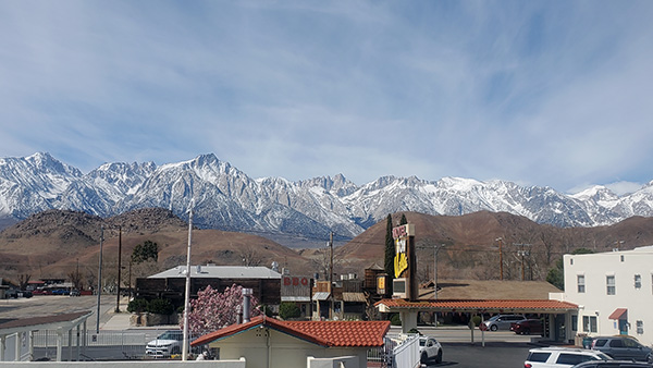 The snowcapped Sierra Nevada mountains, with Mt. Whitney in the center, overlooking the Alabama Hills and the town of Lone Pine, CA.