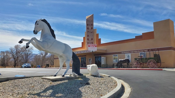 The front of the Museum of Western Film History in Lone Pine, CA. There's a statue of a horse on its hind legs out front.